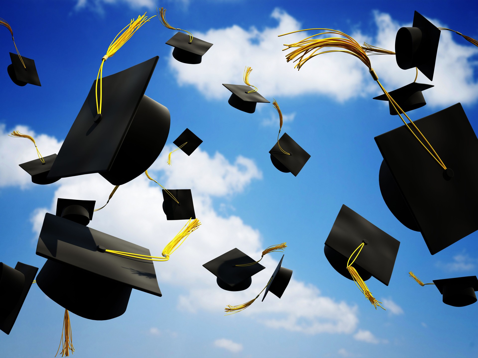 Graduation caps thrown in the air