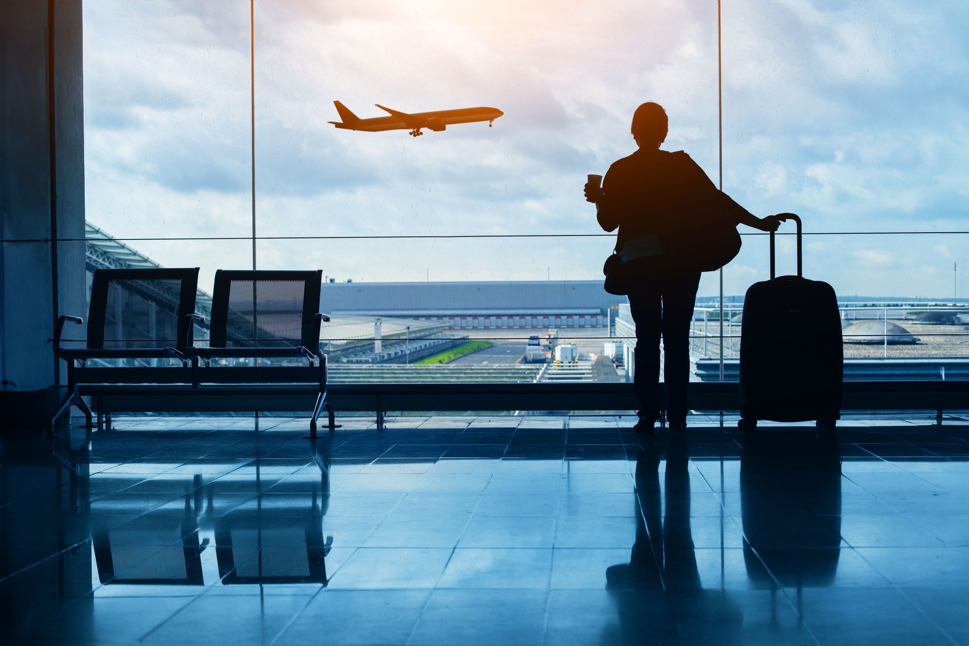 travel by plane, woman passenger waiting in airport, silhouette of passenger in airport